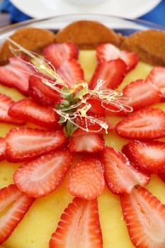 Lovely strawberry custard biscuit tart with toffee garnish ready to serve.