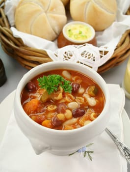 Delicious minestrone soup with fresh baked bread rolls and butter.