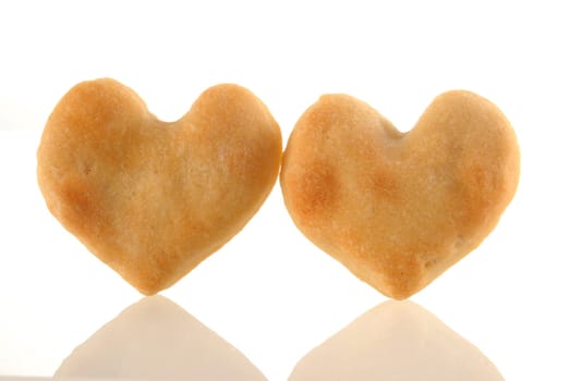 Two heart cookies isolated and its reflection on white background.  Included clipping path, so you can easily cut it out and place over the top of a design.