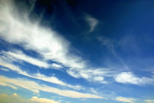 White fluffy clouds on a blue sky background