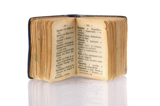 Mini Spanish dictionary focused on success word with its reflection on white background.  Included clipping path, so you can easily cut it out and place over the top of a design.