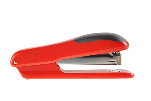 A red and black stapler isolated on white background.  Included clipping path, so you can easily cut it out and place over the top of a design.