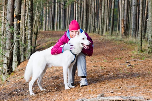 The woman with a dog in a forest park