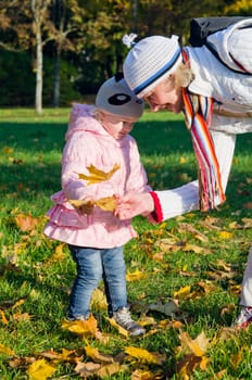 grandmother with the grand daughter in autumn park