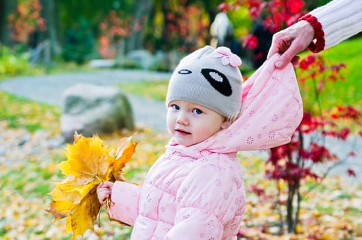 grandmother with the grand daughter in autumn park