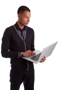 Young african american man using a laptop, isolated on white background