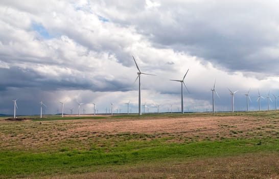 Wind Generators sit atop the hills collecting electricity from the wind