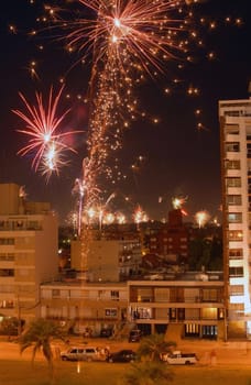 Beautiful night scene celebration of new year with fireworks over the buildings. Montevideo, Uruguay