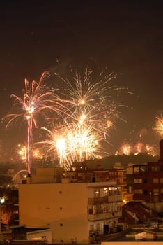 Beautiful new year fireworks celebration over the buildings. Montevideo, Uruguay