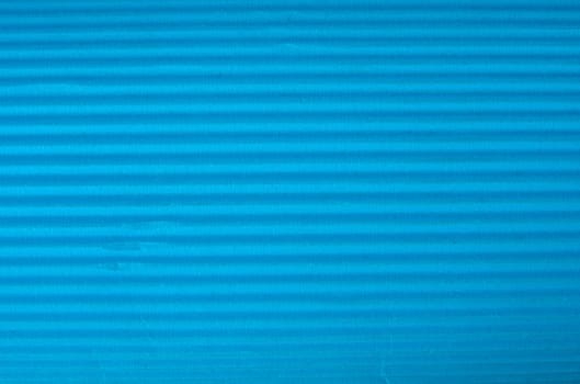 Vintage cyan corrugated cardboard macro close up. Useful as background for design works.