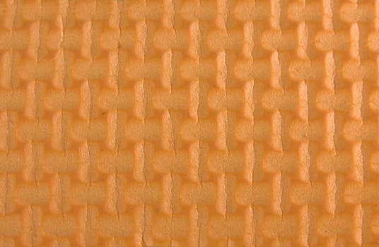 Orange woven rubber texture macro shot. Useful as background for design.