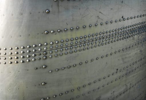 Silvel metal texture with rivets and screws. Useful as background for design works.