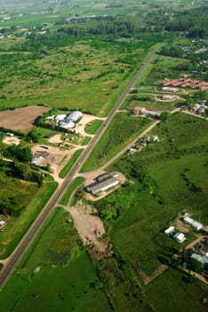 Aerial view of road in green fields in Uruguay.