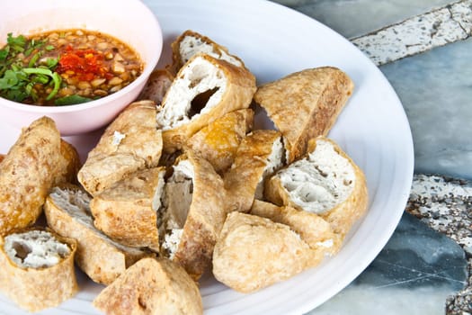 Fried tofu, cut into pieces with sauce.