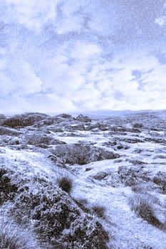 scenic view of abandoned house in rugged rocky snowy irish landscape at christmas