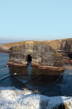 snow covered view of cliffs and the virgin rock in ballybunion county kerry ireland