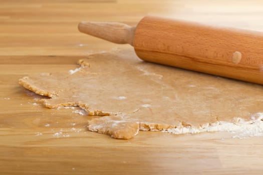 Rolled out dough with rolling pin on a table
