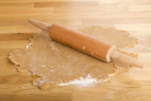 Rolled out dough with rolling pin on a table