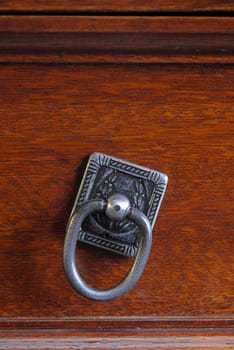 Drawer pull on a wooden texture background