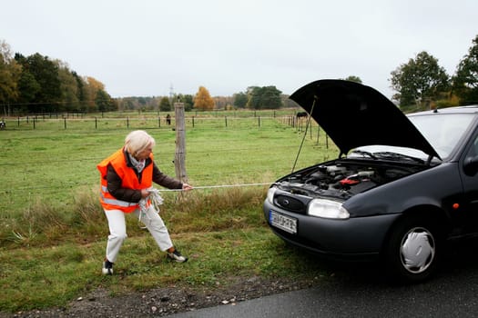 Senior citizen tows car