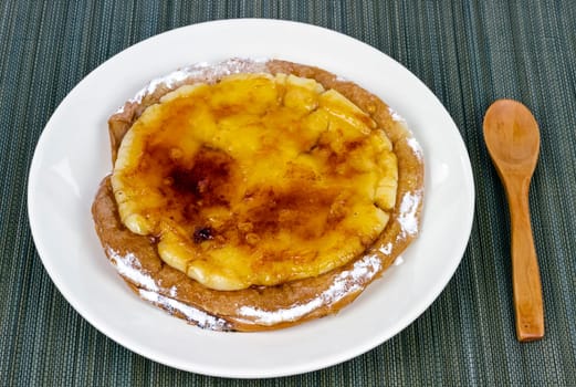Typical ensaimada de Mallorca with a layer of burnt sugar and Catalan custard