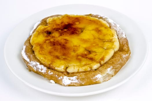 Typical ensaimada de Mallorca with a layer of burnt sugar and Catalan custard