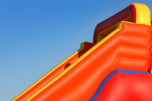 View colorful inflatable blow-up toy on blue sky background