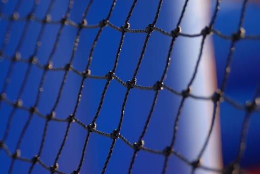 Partial view of a football arch net on sky background