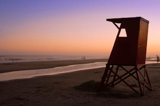 Beautiful quiet sunset at Uruguay beach with lifeguard cabin.
