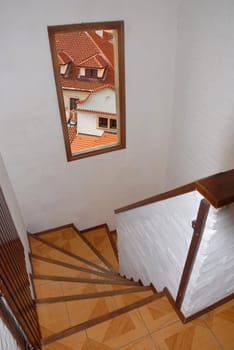 staircase with window with view to city roofs
