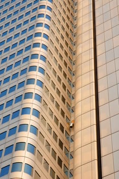 Golden skyscraper reflecting a blue sky