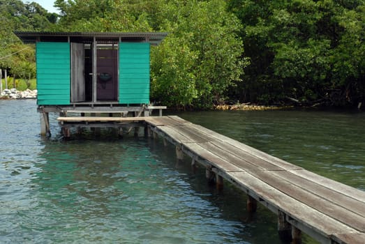 Small wooden bath house at the end of the bridge