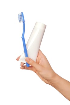 Tooth-paste and brush at in the girl's hand