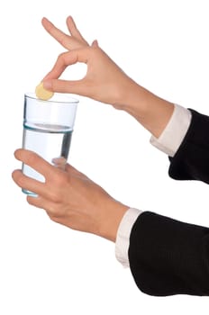 Businesswoman throws a pill from headache to the glass with water