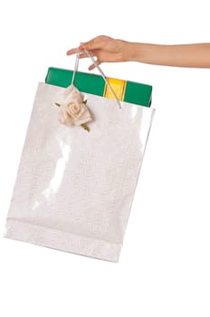 Paper bag with a green box and with a yellow ribbon from the supermarket