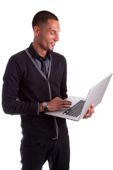 Young african american man using a laptop, isolated on white background