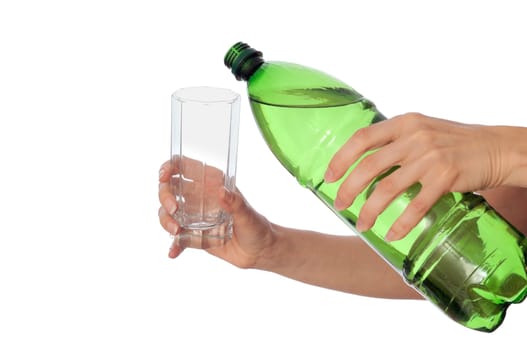 Woman pouring water to a glass from the bottle