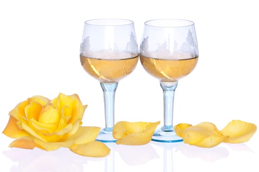 two tumblers of champagne with yellow rose in the restaurant
