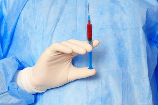 doctor holding a syringe with new synthetic drug mixed with blood