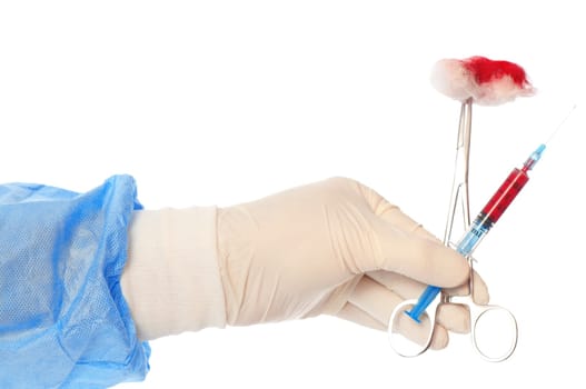 syringe and clamp with swab in the hand of the surgeon during a surgery