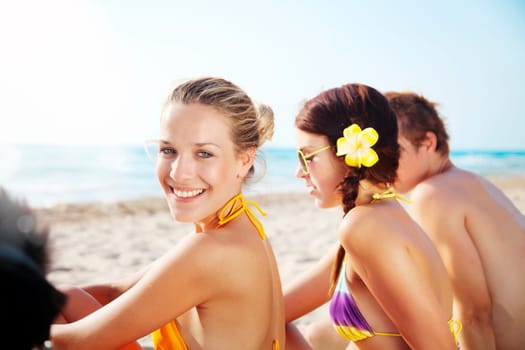 group of young people enjoying the beach