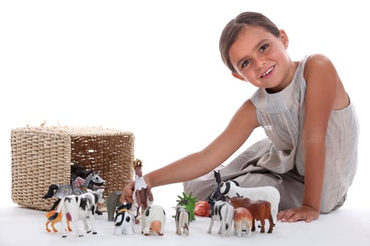 Little girl playing with toy animals
