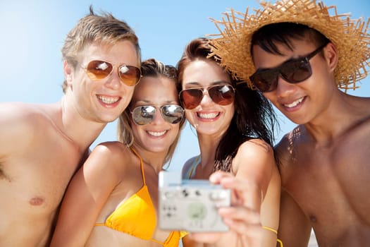 group of young people taking a photograph