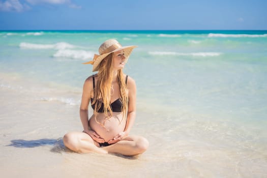 Radiant and expecting, a pregnant woman stands on a pristine snow-white tropical beach, celebrating the miracle of life against a backdrop of natural beauty.