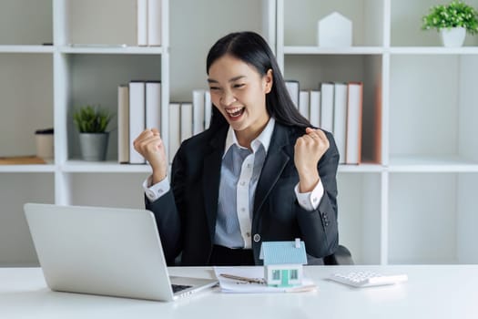 Real estate broker raised hand with happy feeling after posting listing for sale, house can now sold.