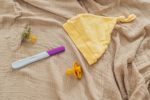 A composition of essential pregnancy attributes: a positive pregnancy test, ultrasound image, tiny pacifier, and a soft baby's cap, embodying the journey to motherhood.