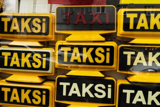 The signs from the taxi cars with the inscription lie one on top of the other.
