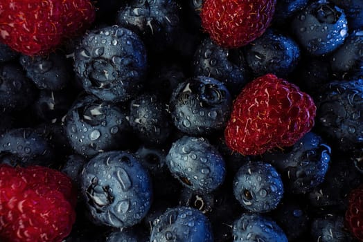 Abstract colorful berries, extreme macro. Wild ripe forest raspberries, blueberries. Fresh fruits, harvest background. High quality photo