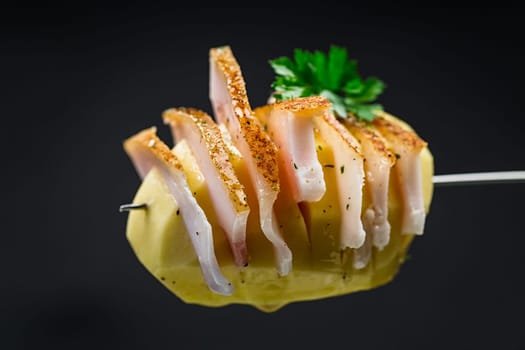 Raw potatoes prepared for baking, with lard isolated on black background