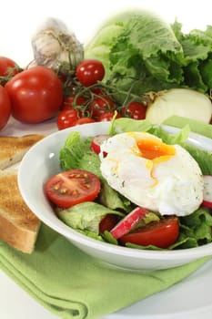 mixed colorful salad with poached egg